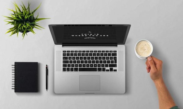 Laptop on desk with coffee